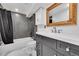 Basement bathroom with black and white geometric tile and modern vanity at 9040 Yucca Way, Thornton, CO 80229