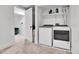 Basement laundry room with washer, dryer, and shelving at 9040 Yucca Way, Thornton, CO 80229