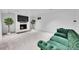 Finished basement recreation room with fireplace and green velvet couch at 9040 Yucca Way, Thornton, CO 80229