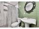 Updated bathroom with green tile and pedestal sink at 9040 Yucca Way, Thornton, CO 80229