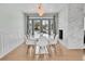 Modern dining room with white table and chairs, and access to the backyard at 9040 Yucca Way, Thornton, CO 80229