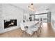 Open concept dining area with a marble fireplace and modern lighting at 9040 Yucca Way, Thornton, CO 80229
