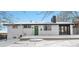 White brick ranch home with green door, snow covered yard at 9040 Yucca Way, Thornton, CO 80229