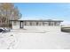 House exterior with snowy backyard and sunroom addition at 9040 Yucca Way, Thornton, CO 80229