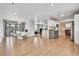 Open concept kitchen with gray cabinets and hardwood floors at 9040 Yucca Way, Thornton, CO 80229