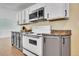 Updated kitchen featuring white cabinets and a gas range at 9040 Yucca Way, Thornton, CO 80229