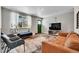 Spacious living room with a large TV and comfortable seating at 9040 Yucca Way, Thornton, CO 80229