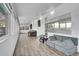 Bright living room, large windows, wood floors, and couches at 9040 Yucca Way, Thornton, CO 80229