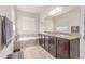 Primary bathroom with double sinks, granite counters, and a soaking tub at 24043 E Florida Ave, Aurora, CO 80018