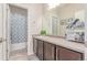 Bathroom with vanity, patterned shower curtain, and tile flooring at 24043 E Florida Ave, Aurora, CO 80018