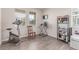 An exercise room with an exercise bike, a window, and laminate flooring provides a dedicated fitness area at 24043 E Florida Ave, Aurora, CO 80018
