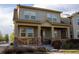 Inviting home exterior with a cozy porch, stone accents, and large windows offering plenty of natural light at 24043 E Florida Ave, Aurora, CO 80018
