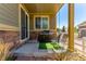 Inviting front porch with a porch swing, grill, and stone accents enhances curb appeal and outdoor comfort at 24043 E Florida Ave, Aurora, CO 80018