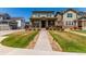 Charming two-story home with a landscaped front yard and inviting covered porch at 24043 E Florida Ave, Aurora, CO 80018