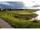Scenic golf course view with lush green fairways, mature trees, and a serene pond, perfect for golf enthusiasts at 24043 E Florida Ave, Aurora, CO 80018