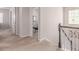 Hallway with staircase that has white and brown railings and doors leading to other rooms in the house at 24043 E Florida Ave, Aurora, CO 80018