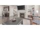 Open-concept living space with modern fireplace and built-in shelving with luxury finishes at 24043 E Florida Ave, Aurora, CO 80018