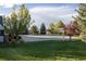 Community pool area with a covered pool, surrounded by lush greenery and mature trees, providing a tranquil setting at 24043 E Florida Ave, Aurora, CO 80018