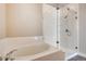 Bright bathroom with a soaking tub and glass shower enclosure at 274 Marlowe Dr, Erie, CO 80516