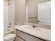 Bathroom with white marble countertop and a shower-tub combo with white tiling at 274 Marlowe Dr, Erie, CO 80516