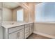 Bright bathroom with double vanity sinks, quartz countertops, and large mirror at 274 Marlowe Dr, Erie, CO 80516