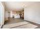 Open-concept dining area with wood-look floors offering seamless transitions to a kitchen with gray cabinets at 274 Marlowe Dr, Erie, CO 80516