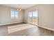 Dining area showcasing wood-look floors, a modern chandelier, and sliding glass doors to the backyard at 274 Marlowe Dr, Erie, CO 80516