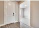 Inviting entryway boasting wood-look floors and neutral walls adjacent to a carpeted living area at 274 Marlowe Dr, Erie, CO 80516