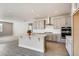 Modern kitchen featuring gray cabinets, a white island, stainless steel appliances, and wood-look floors at 274 Marlowe Dr, Erie, CO 80516