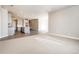 Open-concept living area with a view of the kitchen featuring gray cabinets and an island at 274 Marlowe Dr, Erie, CO 80516