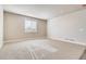 Bright living room featuring neutral carpet, white trim, and natural light through a large window at 274 Marlowe Dr, Erie, CO 80516