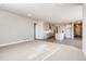 Open-concept living room showcasing the kitchen with an island, gray cabinets and neutral paint at 274 Marlowe Dr, Erie, CO 80516