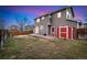 A view of the home's backyard with a storage shed, a patio, and a patch of grass at 12243 N Ivanhoe Cir, Brighton, CO 80602