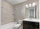 Clean bathroom with tub shower combination and dark vanity at 6327 Agave Ave, Castle Rock, CO 80108