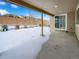 Covered patio overlooking a snowy backyard at 6327 Agave Ave, Castle Rock, CO 80108