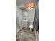 Bathroom features modern vanity, toilet, and shower/tub combo with gray tile at 1977 S Yates S St, Denver, CO 80219