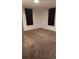This bedroom is carpeted with black curtains covering the windows at 1977 S Yates S St, Denver, CO 80219