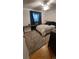 Relaxing bedroom featuring a cozy bed with plush pillows, soft carpet and natural light at 1977 S Yates S St, Denver, CO 80219