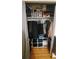 Organized closet with hanging clothes, storage shelves and modern wood flooring at 1977 S Yates S St, Denver, CO 80219
