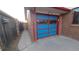 A single car garage featuring a distinctive, brightly painted door at 1977 S Yates S St, Denver, CO 80219
