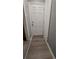 Hallway with a white door and wood flooring leading to the exterior at 1977 S Yates S St, Denver, CO 80219