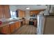 Kitchen featuring wood cabinets, stainless steel appliances, and modern lighting at 1977 S Yates S St, Denver, CO 80219