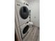 Modern stackable Samsung washer and dryer with a toilet in a compact laundry space at 1977 S Yates S St, Denver, CO 80219