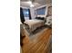 Cozy main bedroom featuring hardwood floors, modern decor, and plenty of natural light at 1977 S Yates S St, Denver, CO 80219