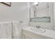 Clean half bathroom featuring vanity, mirror, and towel rack at 544 S Xenon Ct, Lakewood, CO 80228