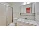 Simple bathroom featuring a glass shower enclosure, vanity, and modern sink basin at 544 S Xenon Ct, Lakewood, CO 80228
