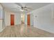 Spacious bedroom with wood-look flooring, ceiling fan, and bright red doors at 544 S Xenon Ct, Lakewood, CO 80228