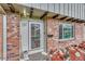 Brick facade with decorative landscaping and a glass-paneled front door at 544 S Xenon Ct, Lakewood, CO 80228
