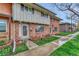 Charming townhouse with brick facade, tidy landscaping, and cozy front porch seating at 544 S Xenon Ct, Lakewood, CO 80228