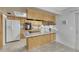 Spacious kitchen with wood cabinets, and a skylight offering natural light at 544 S Xenon Ct, Lakewood, CO 80228